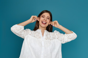 happy woman in white dress is fooling around.