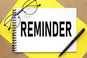 REMINDER. text on notepad on bright stiff backing and craft background