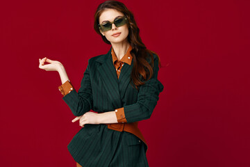 woman in suit sunglasses gesture with hands isolated background studio