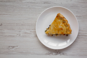 A Piece of Chicken Pot Pie on a white plate, top view. Flat lay, overhead, from above. Copy space.