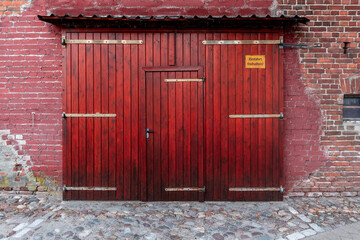 Red door and a brick wall.