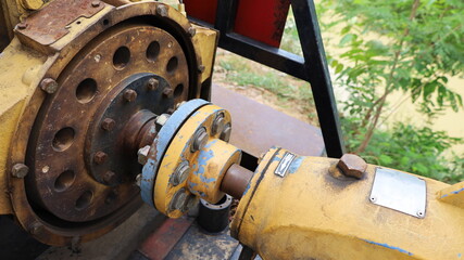 Two flanges with bolts and nuts. The hollow flange transmits the force from the engine to the pulley. Selected focus.