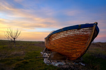 an old boat on an uncultivated field