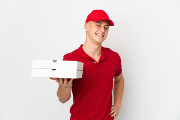 Pizza delivery man with work uniform picking up pizza boxes isolated on white background posing...