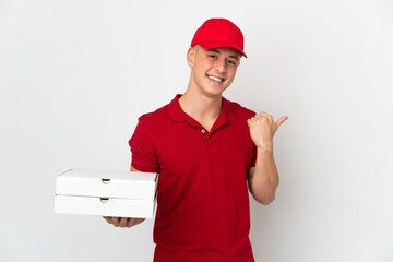 Pizza delivery man with work uniform picking up pizza boxes isolated on white background pointing...