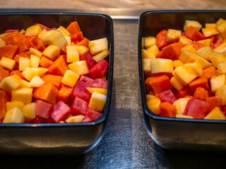 Freshly cut fruits in a black bowl