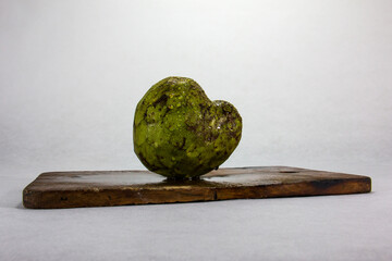 Custard apple typical peruvian fruit, on a wooden board and white background