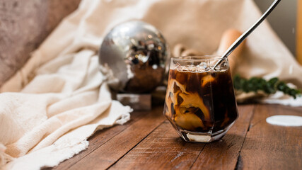 Close-up of iced coffee served on black table at cafe​