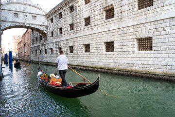 Fototapeta na wymiar Gondola with people on the Venice Canal