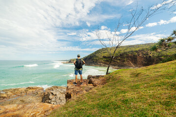 Man Standing on Cliff Looking at Seashore in Summer in Noosa, Queensland, Australia.Explorer Concept