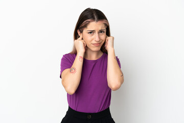 Young caucasian woman isolated on white background frustrated and covering ears