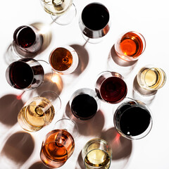 Red, rose and white wine in glasses on white background, top view. Wine bar, shop, winery, wine...