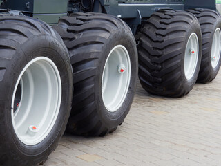 large Wheels with wide tires for large wheeled tractors. Agricultural machinery for working in the...