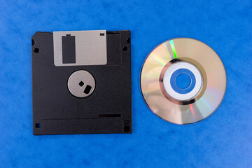 Floppy disk and Classic Compact Disc isolated on blue background