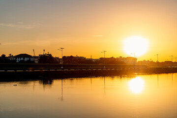 Fototapeta premium Samutprakarn, Thailand Morning sunrise over the River in rural and countryside area near national airport airport with warm tone, There are many of athlete come to cycling and biking around this area 