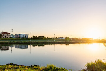 Fototapeta na wymiar Samutprakarn, Thailand Morning sunrise over the River in rural and countryside area near national airport airport, warm cool tone There are many of athlete come to cycling and biking around this area 