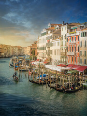Beautiful sunrise in Venice, views of one of its famous canals crisscrossed by gondolas.