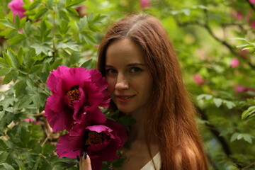 Fototapeta premium portrait of a young woman with purple flowers