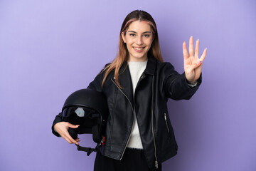 Fototapeta na wymiar Young caucasian woman holding a motorcycle helmet isolated on purple background happy and counting four with fingers