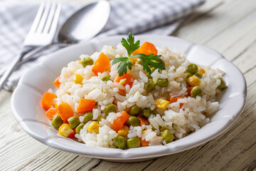 Delicious vegetable rice pilaf with green peas, carrots and sweet corn