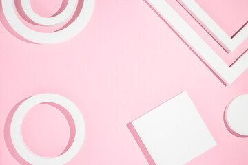 White presentation podiums geometric shapes on a pink background. Top view, flat lay