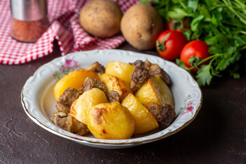 From traditional delicious Turkish food; potato and meat dish in casserole (Turkish name; Guvec tas kebabi)