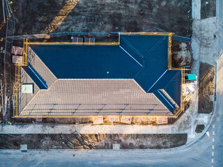 An aerial view looking down on to a freshly laid roof with cement tiles, the roof has been...
