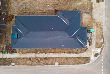 An aerial view looking down on to a freshly laid roof with cement tiles, the roof has been...