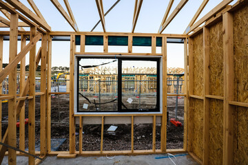 Views of another house being constructed through double glazed windows that are installed in the...