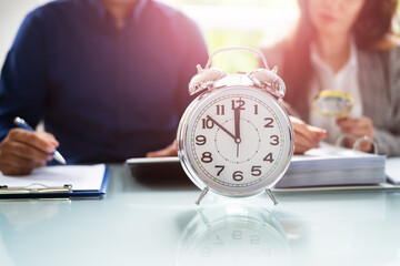 Accountant With Alarm Clock And Calculator
