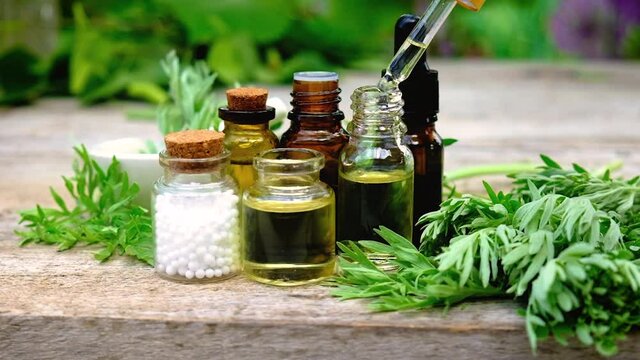Wormwood extract in a small bottle. Selective focus.