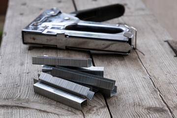 A building stapler on the wooden background