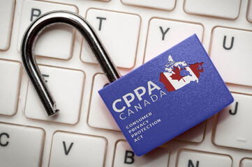 Canada new data protection law (cppa) concept: an open lock over a computer keyboard with the text...