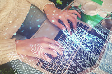 Fototapeta na wymiar Double exposure of woman hands typing on computer and buildings drawing. Smart-city concept.