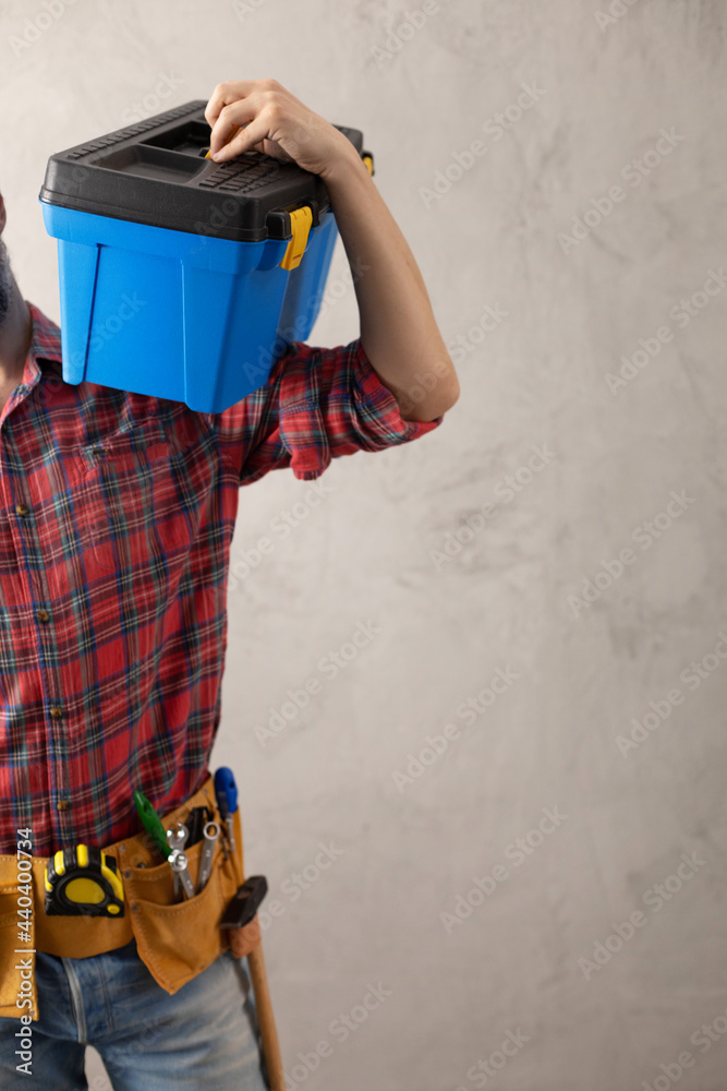 Canvas Prints Man worker holding toolbox and tool belt near wall. Male hand and construction tools