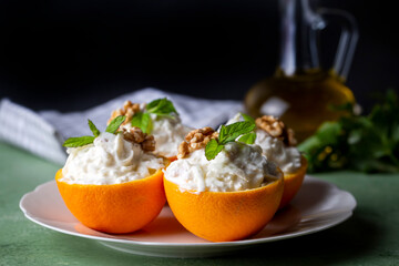 Celery salad with apple and walnuts served in orange cups.