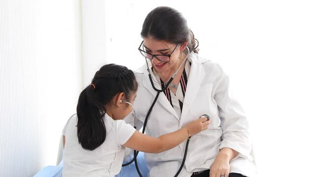 Doctor examining a little girl by stethoscope at hospital. Pediatrician. pediatric checkup in hospital children medical care