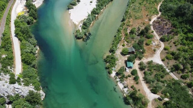 Aerial drone view of river in nature. Beautiful green river and forest in spring. Neretva river, Bosnia and Herzegovina.