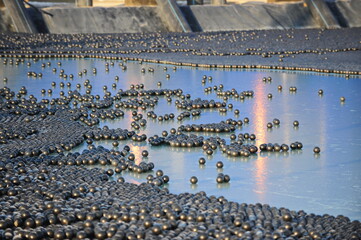 East Kazakhstan region, Kazakhstan - 12.02.2015 : The chemical tank is covered with plastic balls to slow evaporation at the copper cathode mining plant.