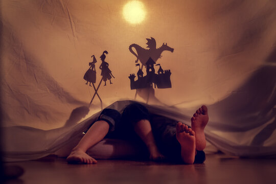 Small children play in the shadow theater. Theatre. Childhood. Fairy tale.
