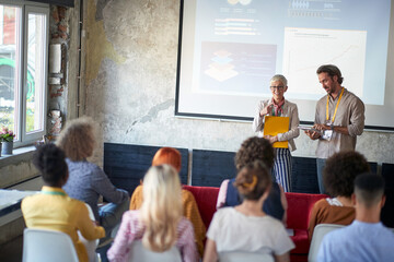 Company employees are following a  presentation in the conference room. Employees, office, work