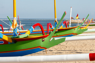 Brightly painted fishing outriggers on the beach at Sanur, Bali, Indonesia
