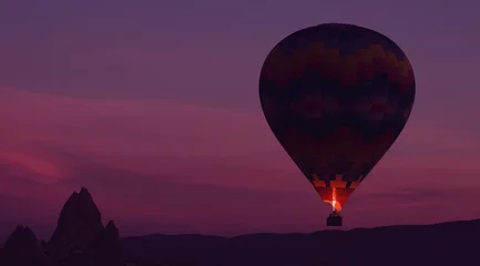 Poster Amazing heavenly background - huge colorful hot air balloon flies in glowing sunset sky © skymediapro