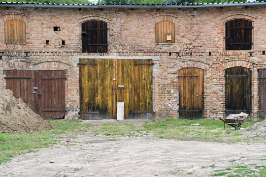 Scheune aus Ziegelsteinen mit vielen  verschlossenen Toren und Fenstern 