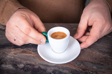 Male hands with a cup of espresso close-up. High quality photo