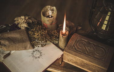 Magical attribute on a table, witchcraft concept, Candle fire, Spells and other rituals