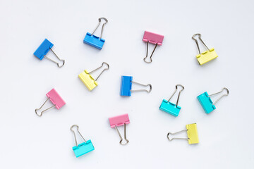 Colorful office paper clips on white background.