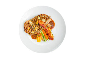 Top view of pork steak with vegetable and sauce isolated on white background.clipping path