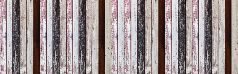 Panorama of Old wooden house wall with many colors in vintage style texture and background seamless