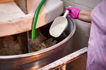 Fototapeta premium Mixing dough with professional kneader machine at the manufacturing. Equipment for making flour products